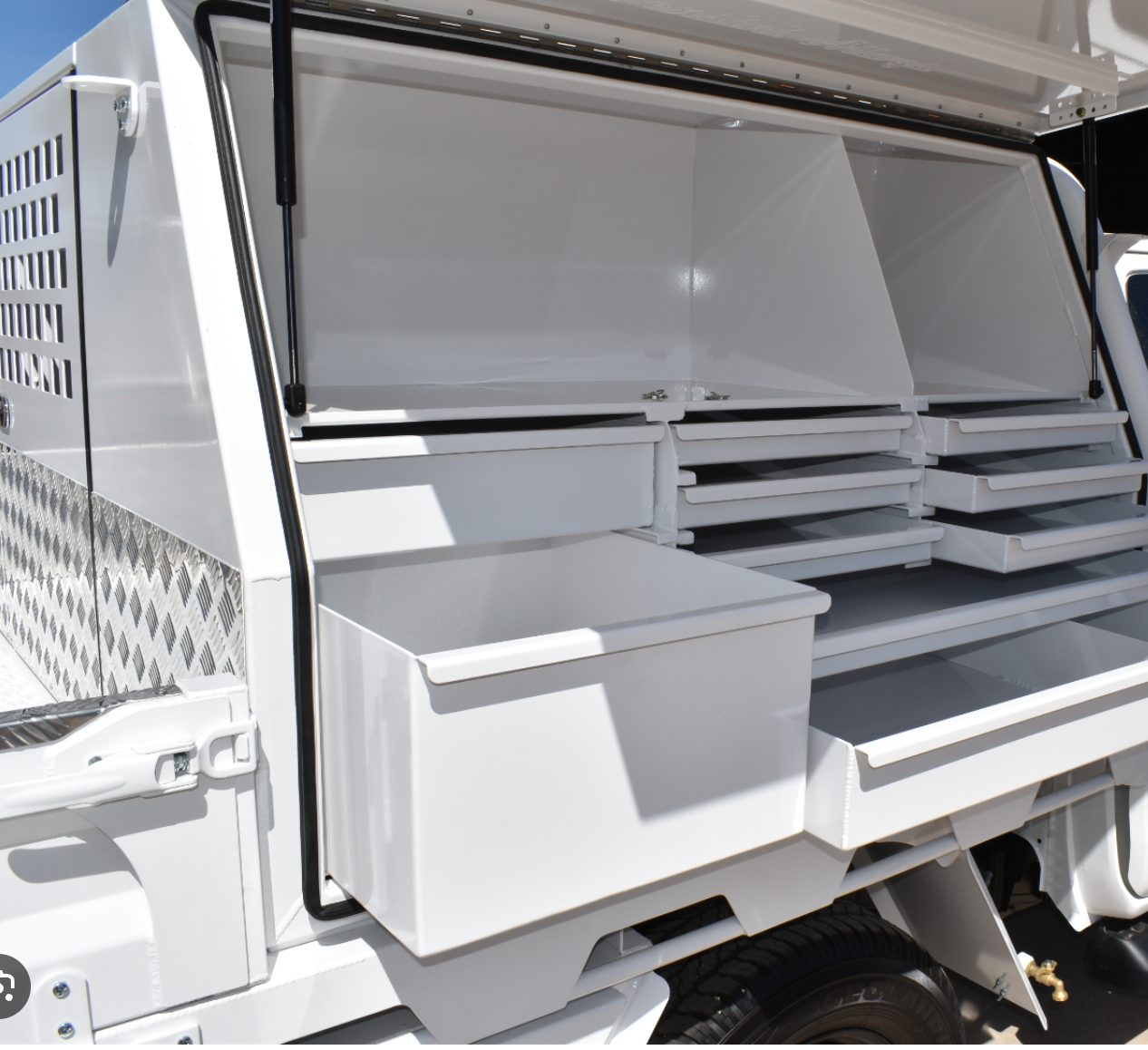 Customised utility vehicle with lockable toolbox and drawer system.